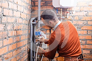 industrial heat engineer worker plumber at boiler room installation.