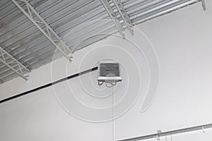 Industrial heater, hanging on the wall of the hall, used for air heating and for cooling with cold water.