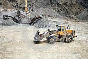 Industrial heavy duty bulldozer moving gravel on construction site