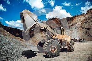 Industrial heavy duty wheel loader working on construction site. Industrial machinery loading