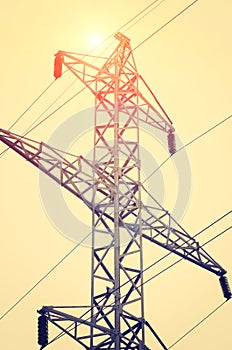 Industrial hightension transformer wire and stand. Tinted photograph