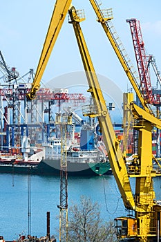 Industrial infrastructure of the seaport - ship, sea, cranes and container warehouse, the concept of sea cargo transportation