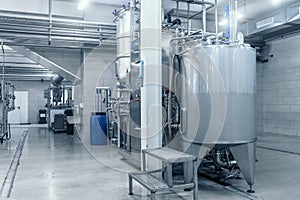 Industrial interior of beverage factory, blue toned. Food and drink production manufacturing