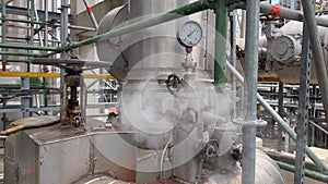 Industrial interior. Close-up of a lot of pipes, pressure gauge and a shut-off valves on the pipes