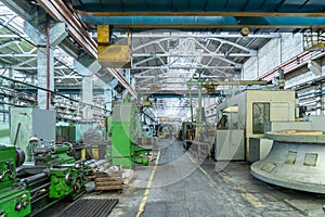Industrial interior of metalworking factory. Workshop with many machine tools for metal processing, grinding, drilling