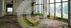 Industrial interior at the old electronic devices factory with big windows and empty floor.