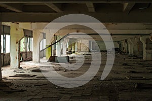 Industrial interior at the old electronic devices factory with big windows and empty floor.