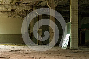 Industrial interior at the old electronic devices factory with big windows and empty floor.