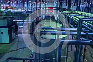 Industrial interior of soft drinks factory with tubes and reservoires