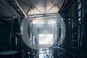 Industrial interior of water or brewery factory or plant production. Large steel tanks or vats. Industry background