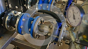 Industrial interior of water pump, valves, pressure gauges, motors inside engine room. Valve and pumps in an industrial
