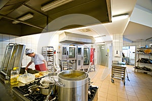 Industrial kitchen interior with busy cooks