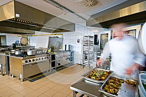 Industrial kitchen interior with busy cooks