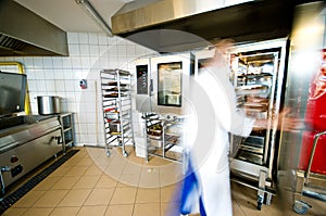 Industrial kitchen interior with busy cooks