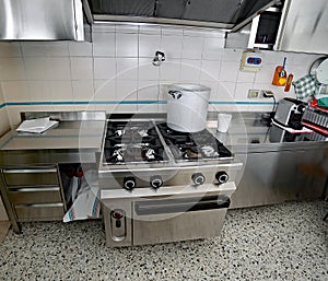 Industrial kitchen with steel furniture and a aluminum pot