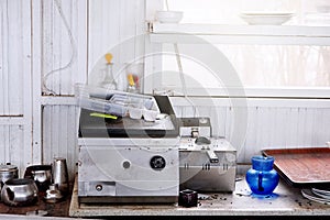 Industrial kitchenware over the counter of an abandoned kitchen