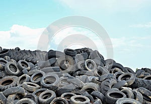 Industrial landfill for the processing of waste tires and rubber tyres. Pile of old tires and wheels for rubber recycling