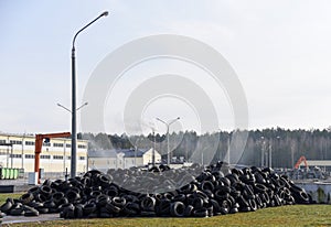 Industrial landfill for the processing of waste tires and rubber tyres. Pile of old tires and wheels for rubber recycling