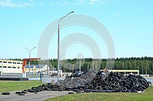 Industrial landfill for the processing of waste tires and rubber tyres. Pile of old tires and wheels for rubber recycling. Tyre