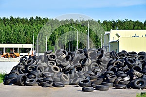 Industrial landfill for the processing of waste tires and rubber tyres. Pile of old tires and wheels for rubber recycling. Tyre