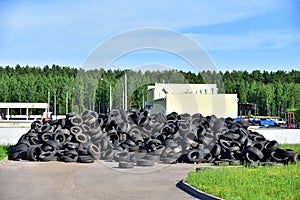 Industrial landfill for the processing of waste tires and rubber tyres. Pile of old tires and wheels for rubber recycling. Tyre