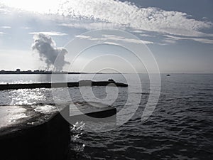 Industrial landscape along the coast. Air polluting factory chimneys