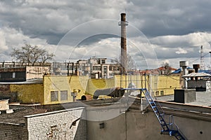 Industrial landscape. Factory plant with yellow walls and pipe.