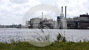 Industrial landscape with grass in a breeze