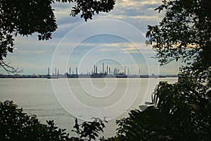 Industrial landscape with large oil refineries in the distance