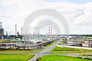 Industrial landscape. Panoramic view of the technological pipes. Plant settings. From the chemical red-white pipes smoke is coming