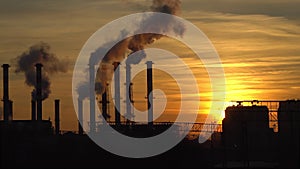 Industrial landscape, the pipes of the thermal power plant at sunset