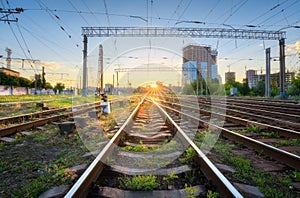 Industrial landscape with railway station, green grass, buildings