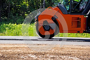 Industrial landscape with rollers that rolls a new asphalt in the roadway. Repair, complicated transport movement