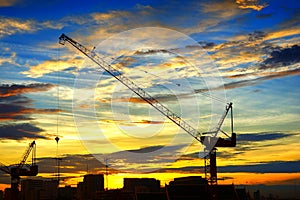 Industrial landscape with silhouettes of cranes on