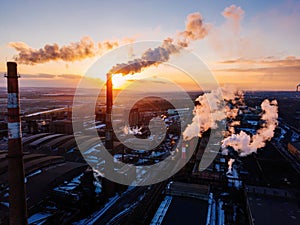 Industrial landscape at the sunset, aerial view. Smoke coming out from factory chimneys