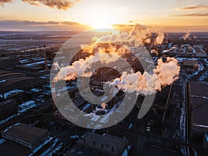 Industrial landscape at the sunset, aerial view. Smoke coming out from factory chimneys