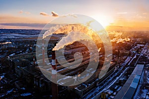 Industrial landscape at the sunset, aerial view. Smoke coming out from factory chimneys