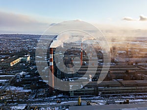 Industrial landscape at the sunset, aerial view. Smoke coming out from factory chimneys