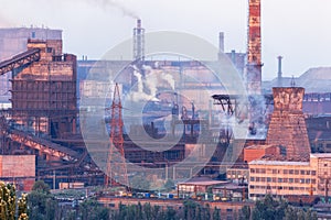 Industrial landscape in Ukraine. Steel factory at sunset. Pipes with smoke. Metallurgical plant. steelworks, iron works. Heavy ind