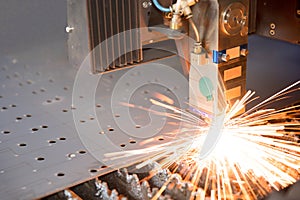 Industrial laser making holes in metal sheet