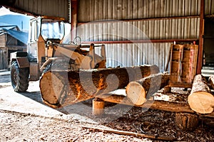 Industrial log loader operating at wood factory