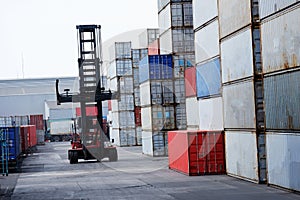 Industrial logistics transport forklift truck transport container box loading stacker at port to truck for shipping export and