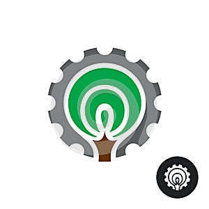 Industrial logo with stylized tree silhouette and gear around