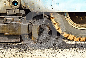 Industrial machine laying asphalt on highway construction