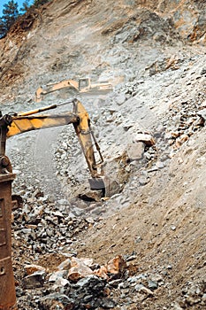 Industrial machineries working on construction site. Details of excavators working on site