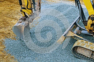 Industrial machinery construction site, excavator moving gravel and rocks for foundation building