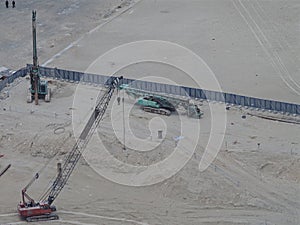 Industrial machines on a construction work site, aerial view.