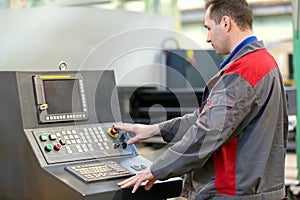 Industrial man worker operating workshop machine