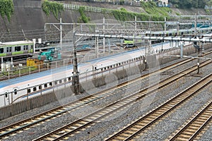 Industrial or mass transit background featuring detail of electrical railroad with local suburban train