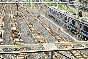 Industrial or mass transit background featuring detail of electrical railroad with local suburban train